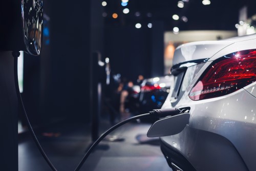 White car parked at an EV fuel charging station