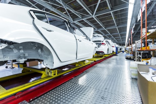 cars on an assembly line with doors ajar